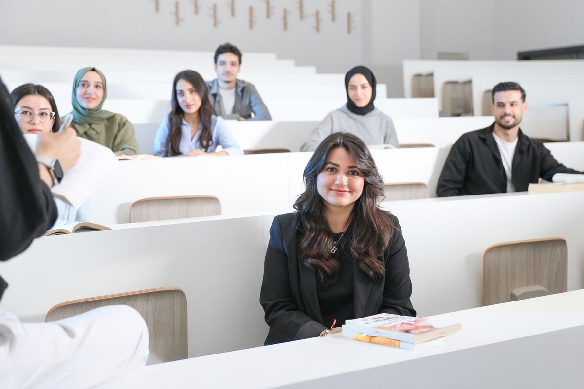 International students smiling in a university lecture theatre