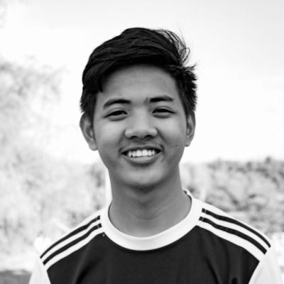 Karim Uddin, a smiling young man in a sports shirt, outdoors