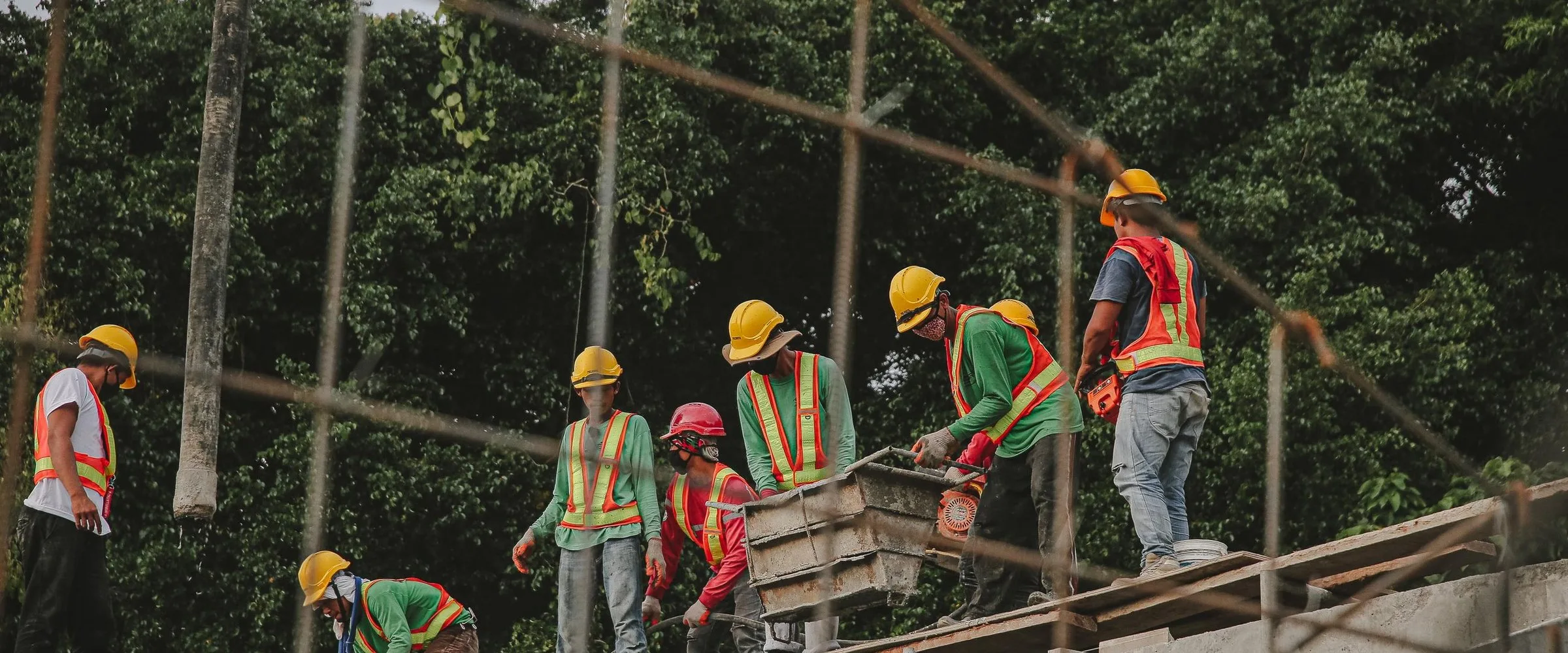 A team of construction workers in hard hats on a building site