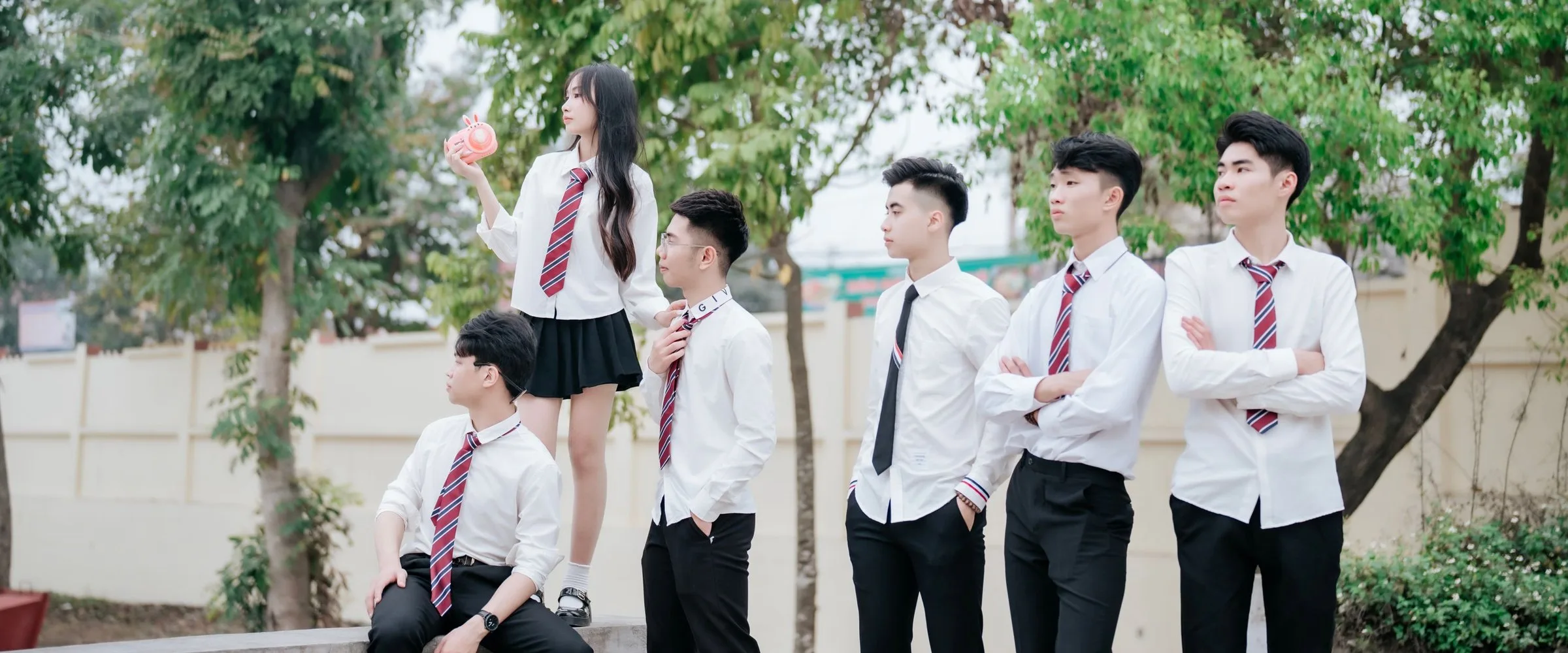 Secondary school pupils in uniform outside their school